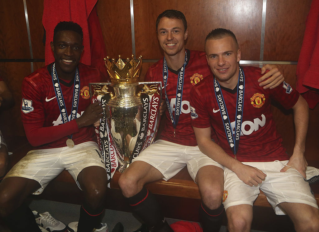 MANCHESTER, ENGLAND - MAY 12: Danny Welbeck, Jonny Evans and Tom Cleverley of Manchester United celebrate with the Barclays Premier League trophy in the dressing room after the Barclays Premier League match between Manchester United and Swansea at Old Trafford on May 12, 2013 in Manchester, England. (Photo by John Peters/Manchester United via Getty Images)