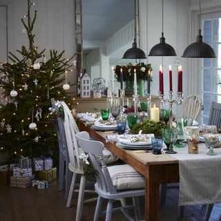 Dining room with large table and mismatched chairs and Christmas decorations