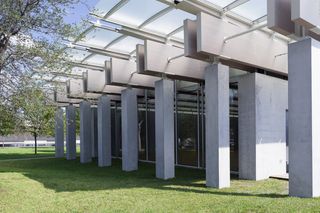 Concrete building with grass and trees