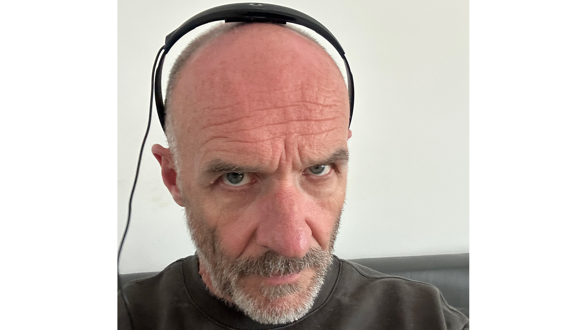 The Bose soundbar's Adaptiq headset mic worn by a man who looks unamused