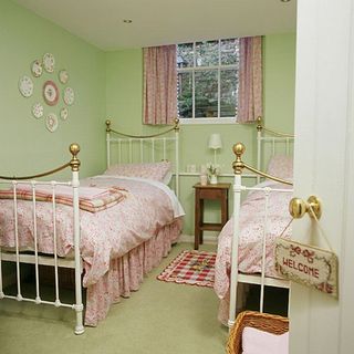 bedroom with pastel green walls and glass window
