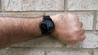 Garmin Venu 2 watch face in front of brick wall