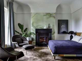 A bedroom with a onyx fireplace