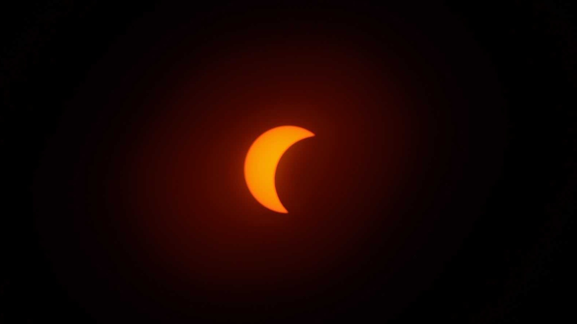 an orange crescent on a black background