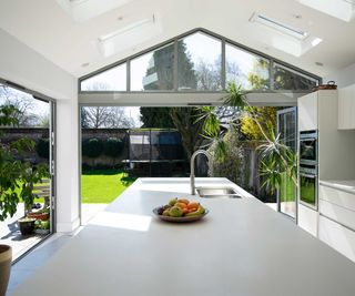 white kitchen with glazed gable and large white kitchen island with sink