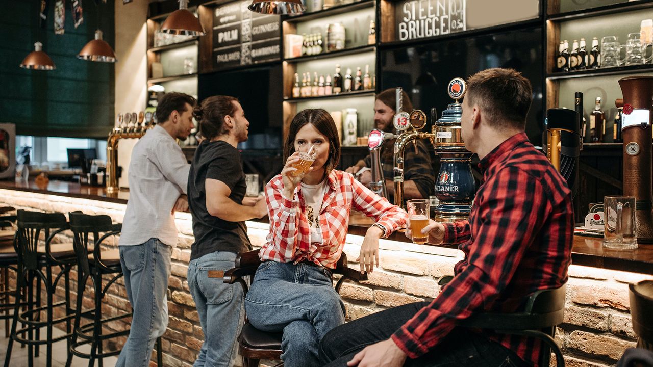 People sat at a bar in a pub