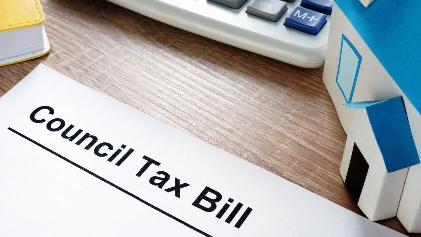 Council Tax Bill and model of house on a desk