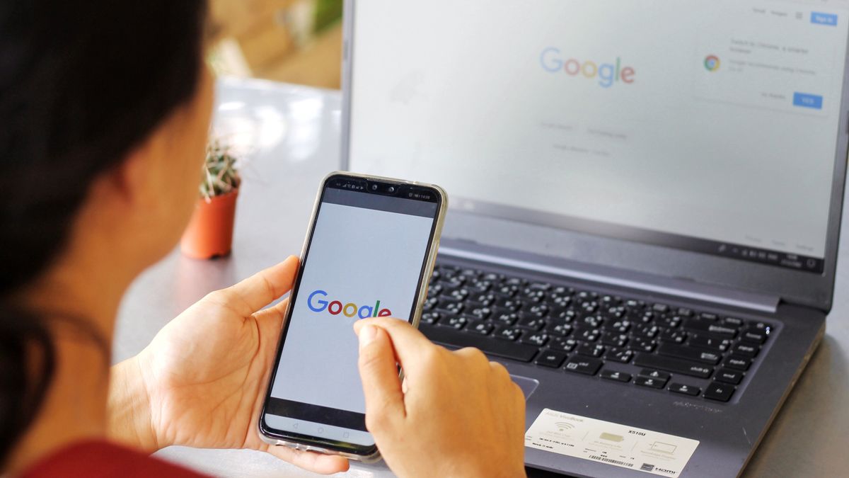 A woman using Google on laptop and smartphone