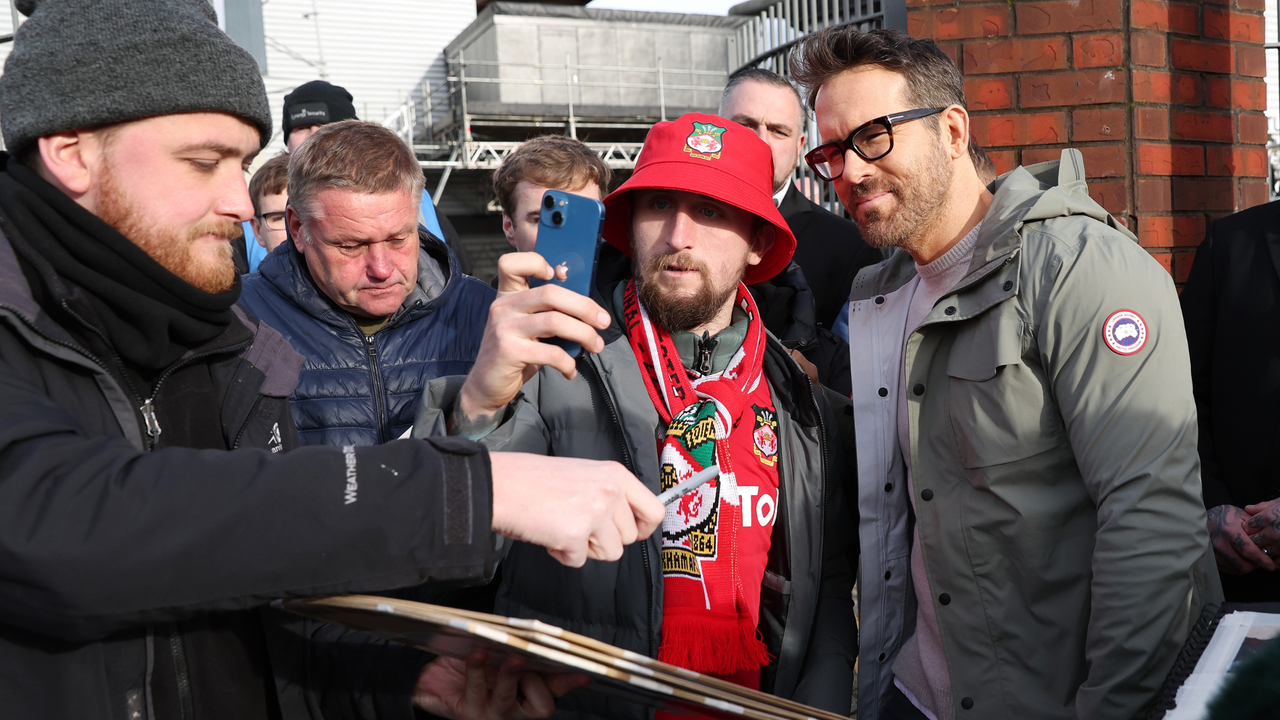 Ryan Reynolds the owner of Wrexham signs autographs for supporters prior to the Emirates FA Cup Fourth Round match between Wrexham and Sheffield United at Racecourse Ground on January 29, 2023 in Wrexham, Wales.