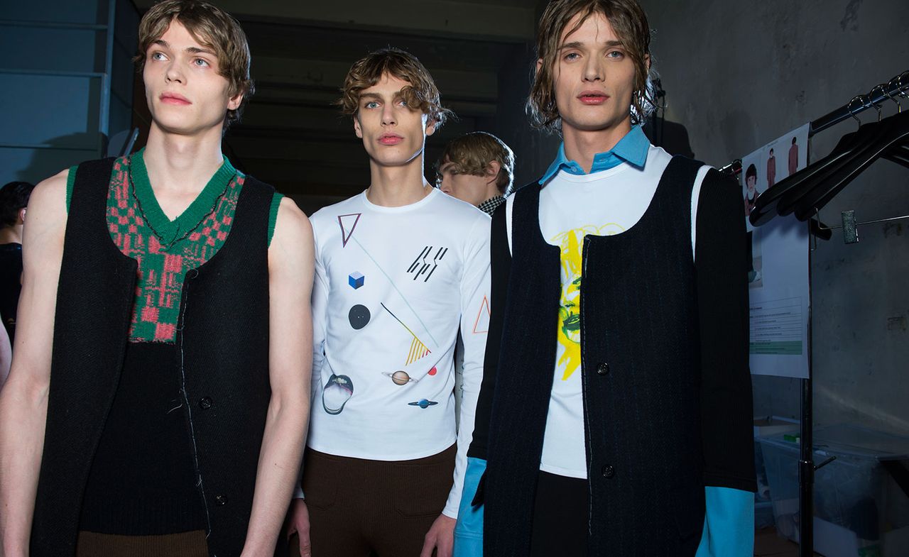 Three male models wearing Raf Simons clothing