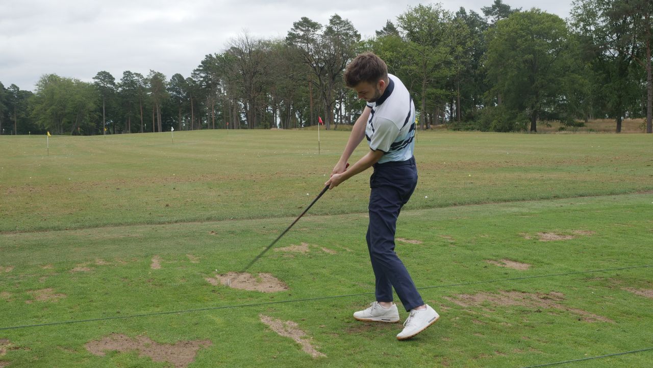 A golfer swinging the SuperSpeed C Club
