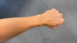 An outstretched arm with no Apple Watch on it.