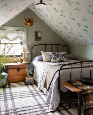 attic kids bedroom with green walls and ceiling wallpaper