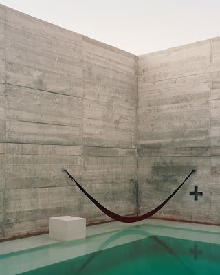 A hammock hangs above the swimming pool, which is inspired by local sinkholes
