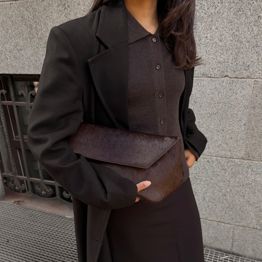 @ingridedvinsen wearing a brown wool coat, collared cardigan, pencil skirt, low heels, and pony hair clutch 