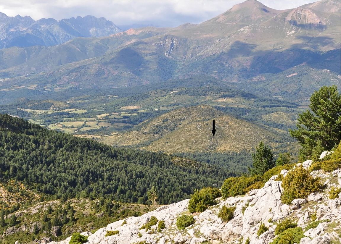 The cave of Els Trocs in the Spanish Pyrenees, indicated here by an arrow, was the scene of a brutal massacre about 7,300 years ago. 