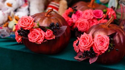 bouquets of pink flowers in gold painted pumpkins
