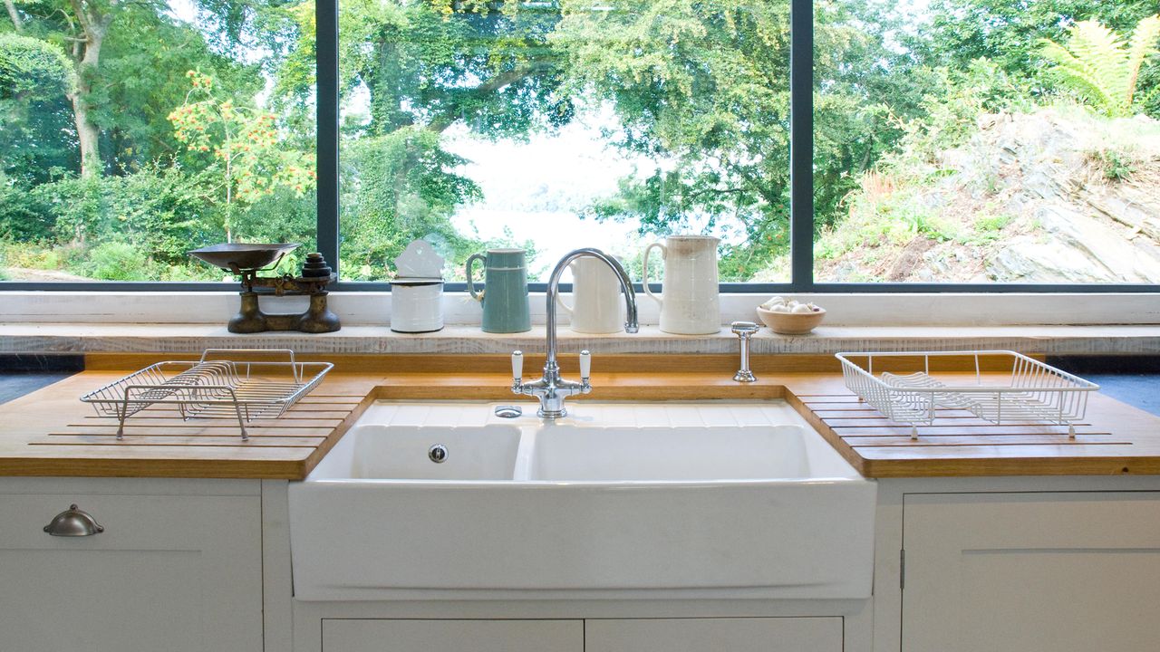 Close up of kitchen sink with view out of window.