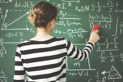 A student at a chalkboard.