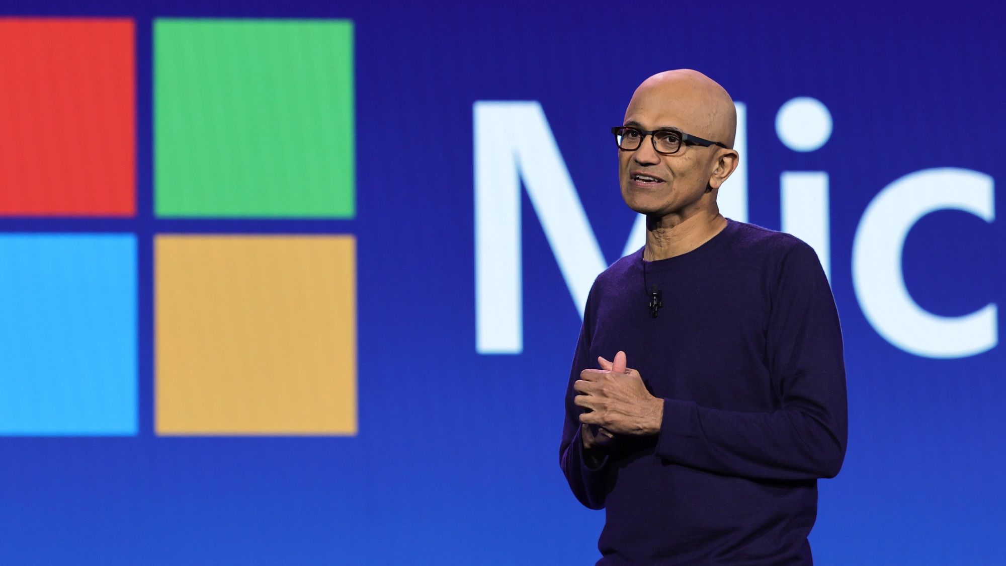 Satya Nadella in front of Microsoft logo at CES 2024