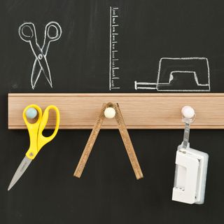 blackboard with scissor and wooden scale