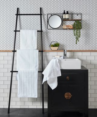 white towels on towel ladder in monochrome bathroom