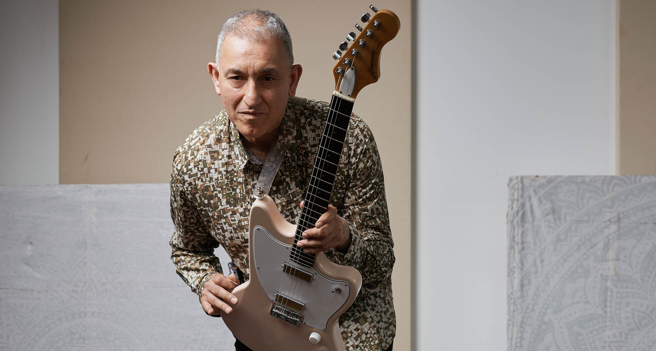Aziz Ibrahim is photographed at home with some of his favourite guitars