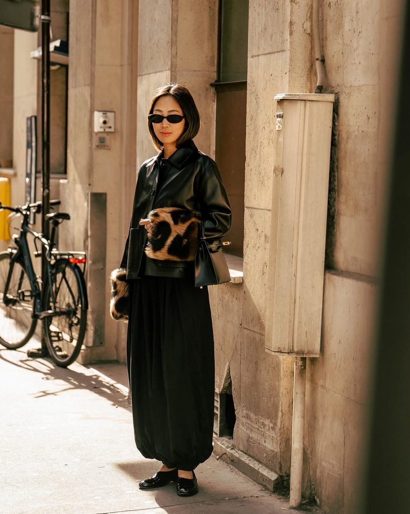 An influencer wearing a black trousers outfit.