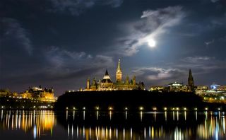 The supermoon rises above the Canadian Parliament on the night of May 5, 2012.
