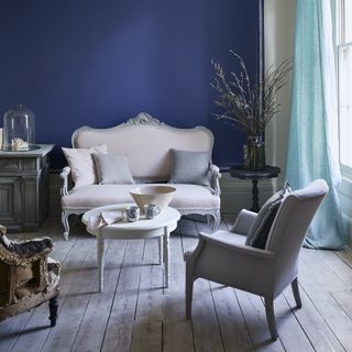 Grey painted coffee table with blue wall