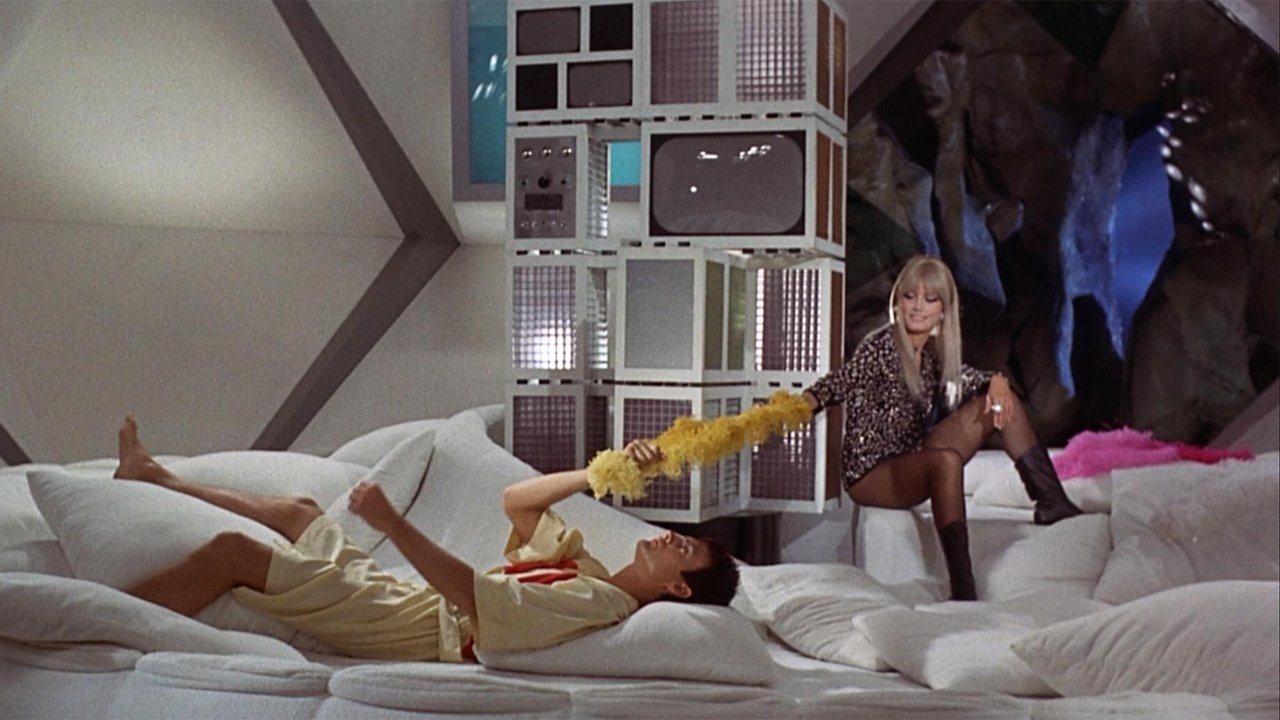 John Phillip Law and Marisa Mell playing on a couch in Danger: Diabolik