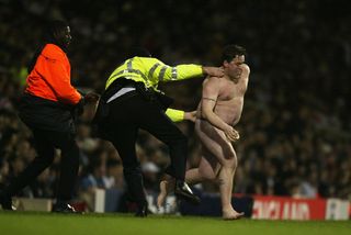 A naked England fan runs onto the pitch during the International Friendly match between England and Australia held on February 12, 2003 at Upton Park in London, England. Australia won the match 3-1.