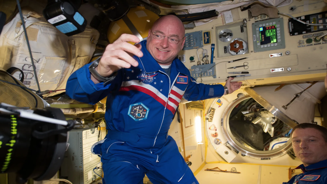a NASA astronaut in a blue jumpsuit on the ISS