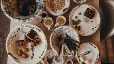 Leanne Ford x il Buco Vita splatter painted tableware styled with Italian bites and coordinating cutlery