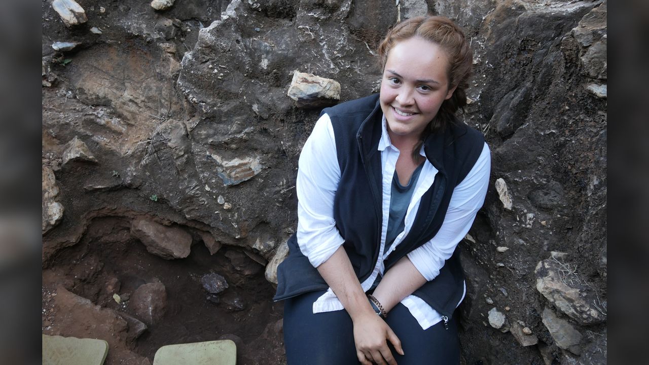 The student who discovered the skull, Samantha Good, stands at the excavation site.