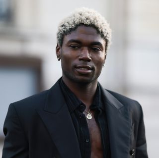 Deon Hinton is seen wearing a black suit, black jacket, black wide pants, black leather boots and a silver chain during the Amiri Menswear Fall/Winter 2024/2025 as part of Paris Fashion Week on January 18, 2024 in Paris, France.