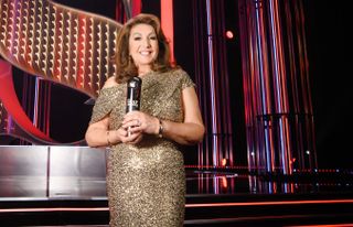 Jane McDonald hosts The British Soap Awards 2023 in a gold dress and holding an award