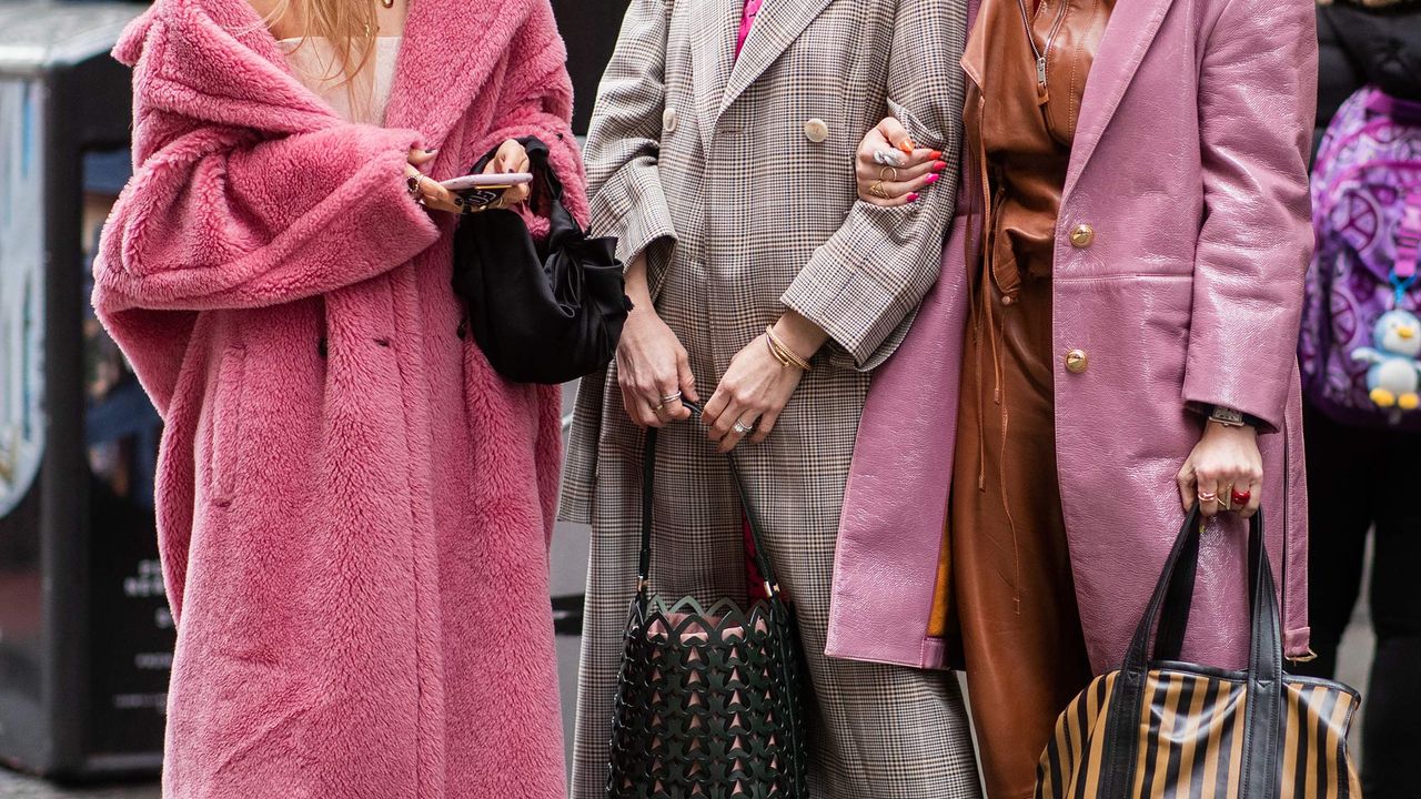 Three attendees at fashion week during New York Fashion Week Autumn Winter