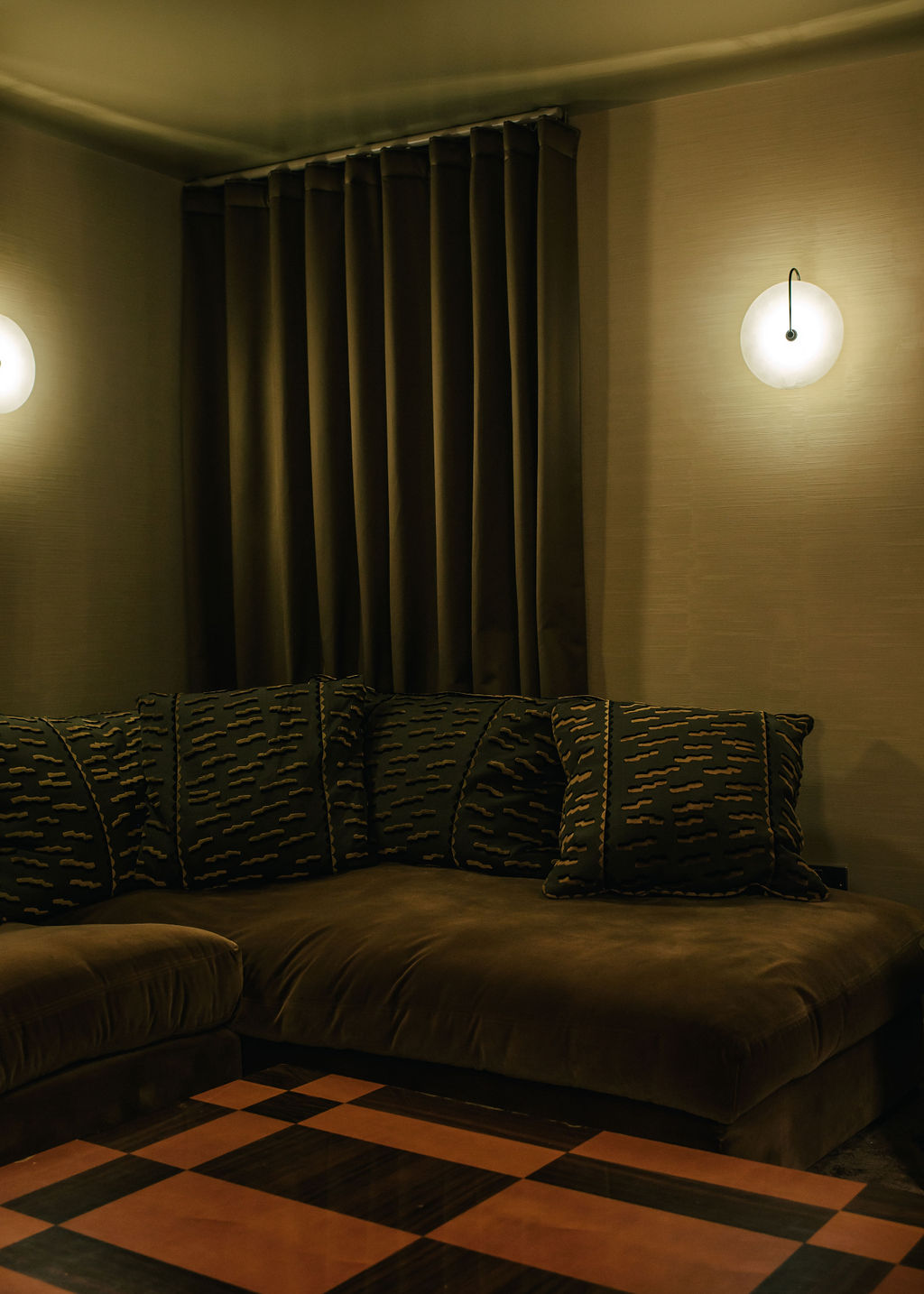 Naturally or beautifully lit rooms distinguished by an earthy palette of cream, green, and wood tones, sleek details, and textural surfaces in fabric, stone, and wood, and softly glowing lighting.