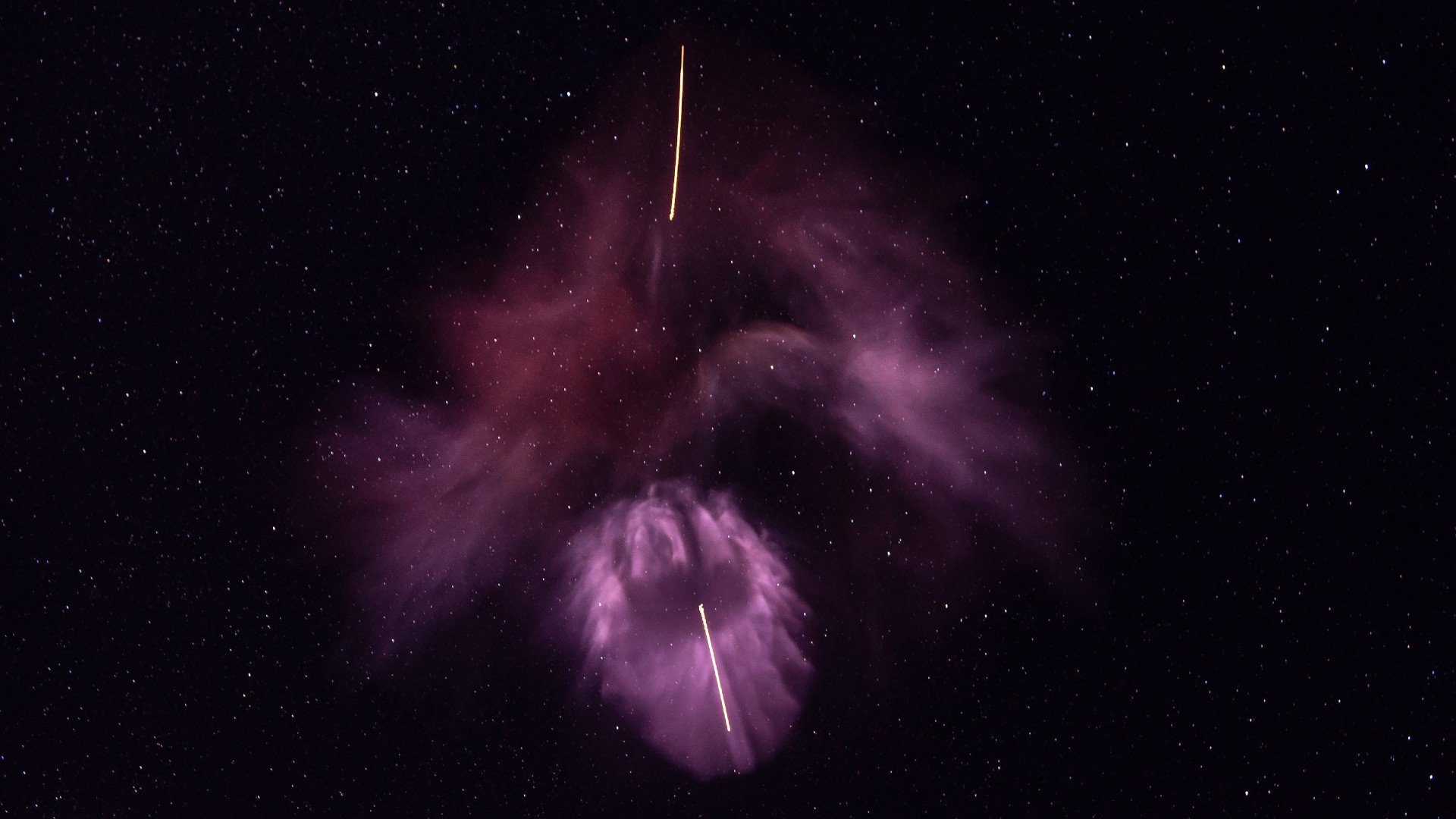 purple clouds of gas against a starry night sky