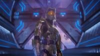 Master Chief stands in a Covenant ship.