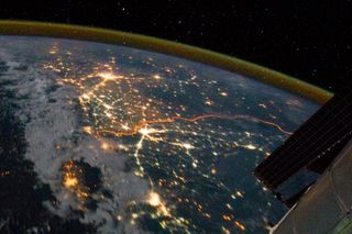 Clusters of yellow lights on the Indo-Gangetic Plain reveal numerous cities large and small in this astronaut photograph of northern India and northern Pakistan.
