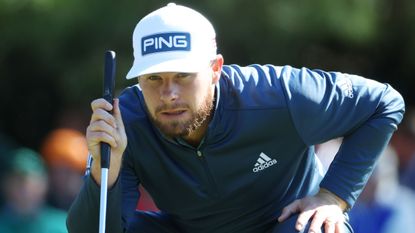 Tyrrell Hatton reads a putt