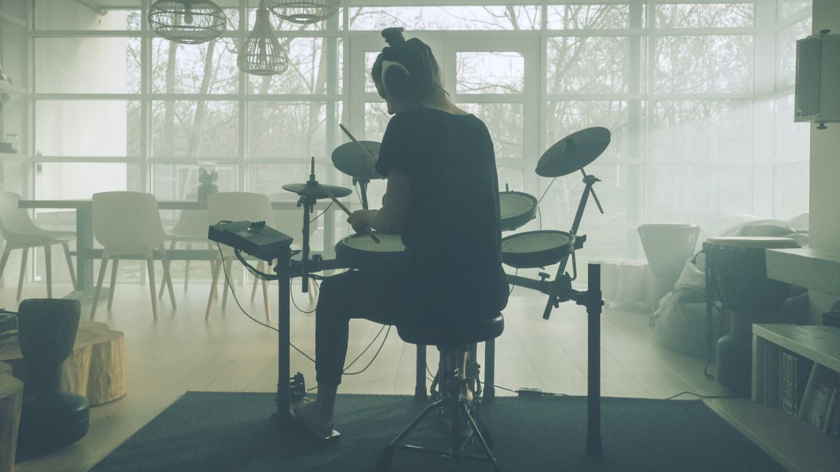 Snare drum with microphone, woman playing drums