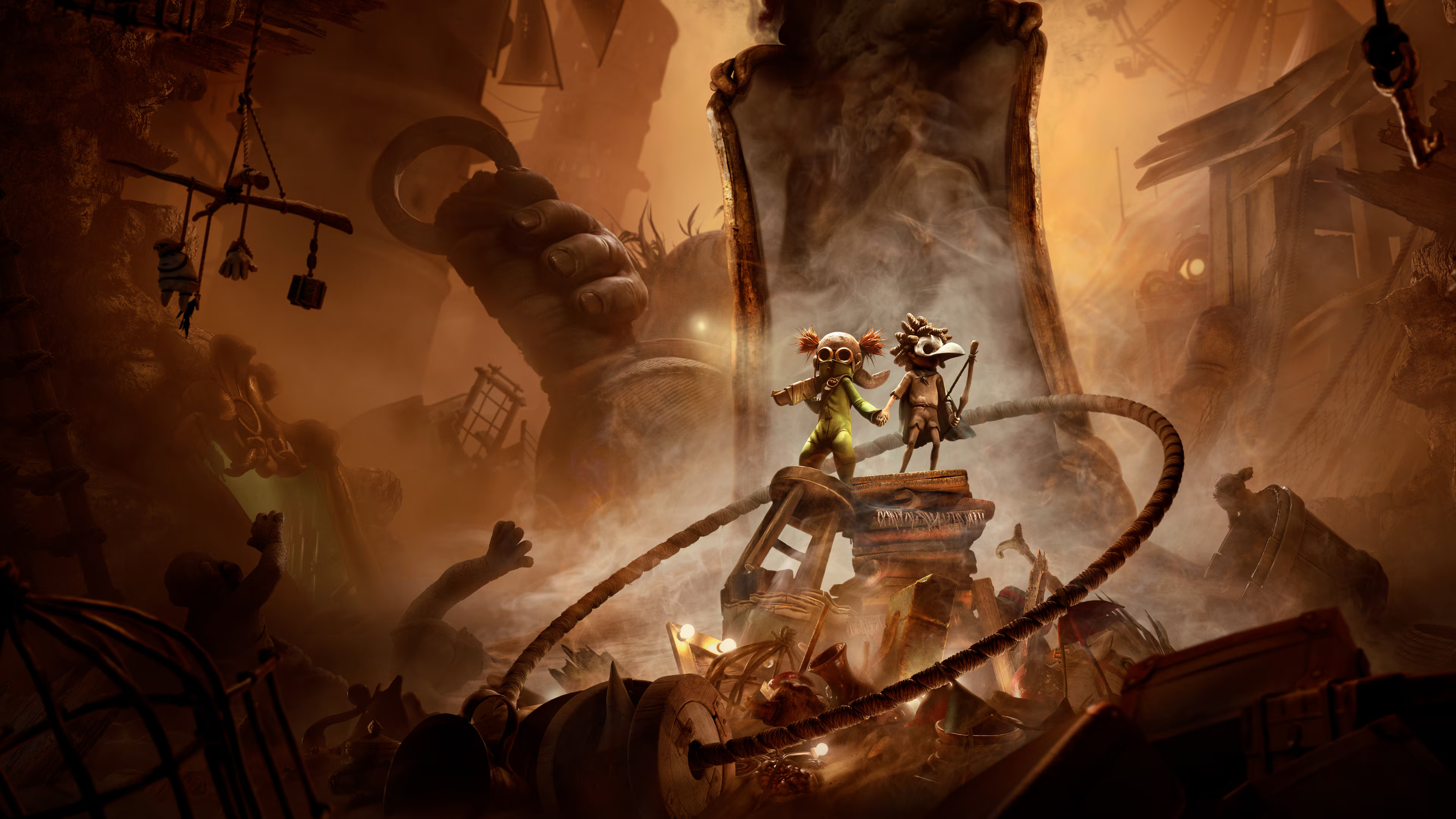 Digital storefront key art for Little Nightmares 3 showing the two masked kids holding hands among a clutter of household items as a large figure with a glowing eye menacingly watches them from the background