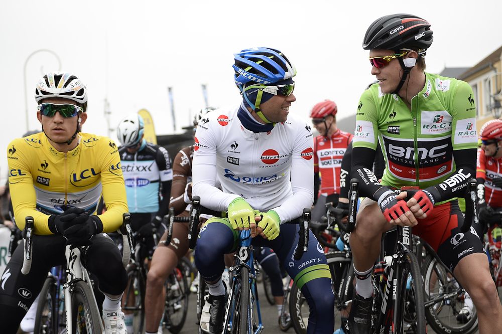 Michal Kwiatkowski wearing the overall leader's yellow jersey, Michael Matthews wearing the best young's white jersey and Rohan Dennis wearing the best sprinter's green jersey wait before the start.