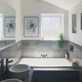 bathroom with white wall and grey tiles and bathtub