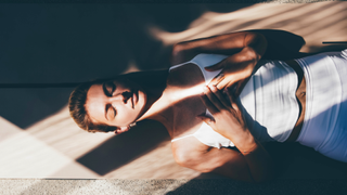 Woman reclined with hands on chest