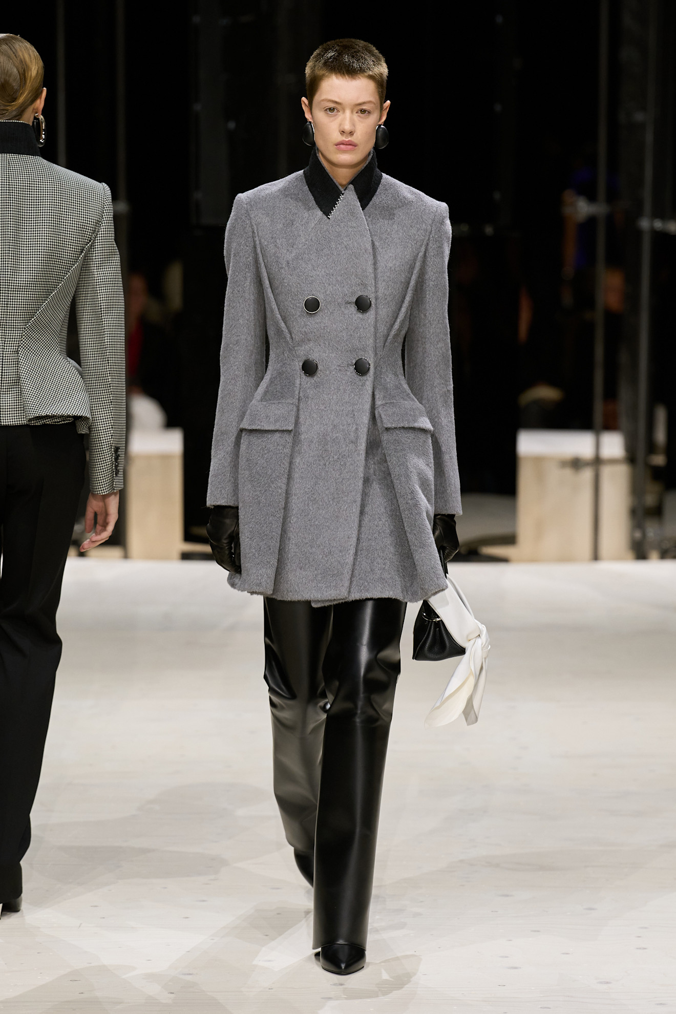 a givenchy model wears knife boots on f/w 26 runway.