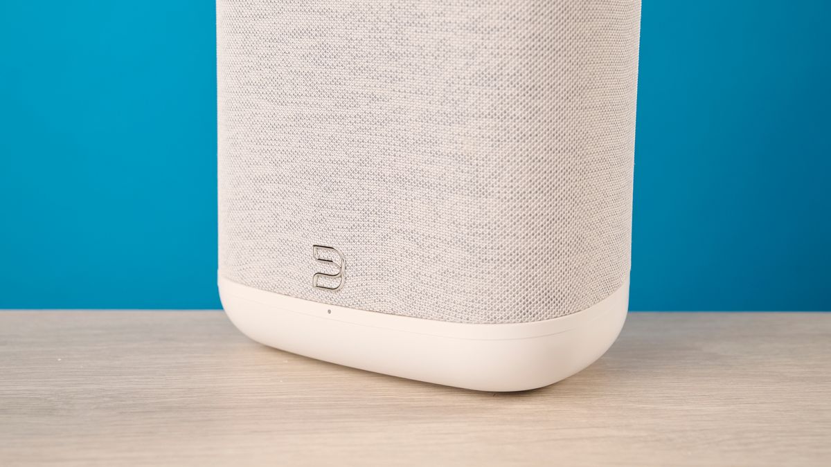 the bluesound pulse flex wi-fi speaker in pale gray photographed against the blue tom's guide background